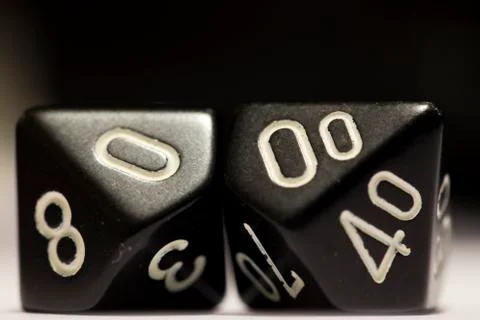 Macro shot of two black dice on their side Photos