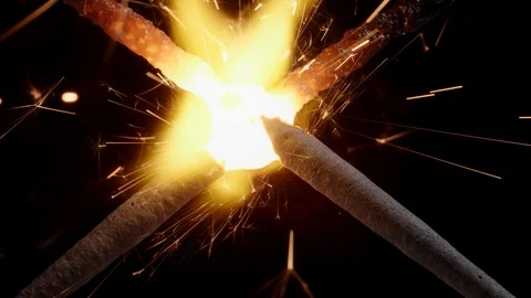 Macro shot of two burning christmas sparklers melting into an X Video stock 119836283