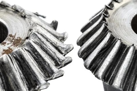 Macro shot of a two damaged bevel gears with beveled teeth, isolated on a whi Foto stock
