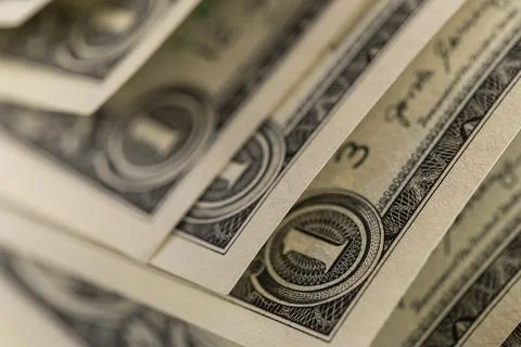 Macro shot of US one dollar bills curved in rows with selective focus on On.. Foto stock
