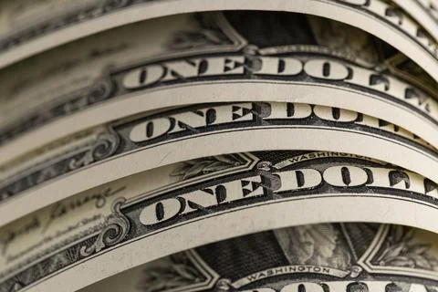 Macro shot of US one dollar bills curved in rows with selective focus on On.. Foto stock
