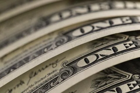 Macro shot of US one dollar bills curved in rows with selective focus on On.. Foto stock