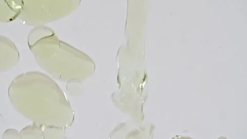 Macro Shot of Various Air Bubbles in Water Rising up on White Background. Liquid Stock Footage 265900542