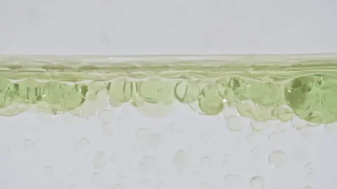 Macro Shot of Various Air Bubbles in Water Rising up on White Background. Liquid Stock Footage 266939974