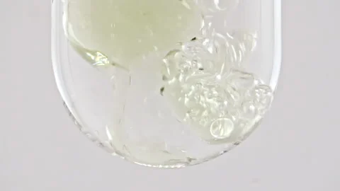 Macro Shot of Various Air Bubbles in Water in Glass Test tube Rising up on White Stock-Footage 272590039