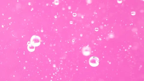 Macro shot of various air bubbles in water rising up on bright pink backgro.. Stock Footage 274554200