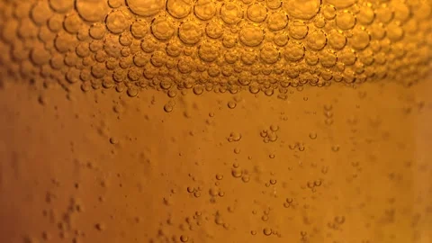 Macro shot of various air bubbles in water rising up on bright brown backgr.. Stock Footage 274554940