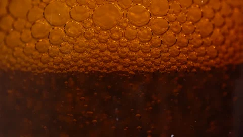 Macro shot of various air bubbles in water rising up on bright brown backgr.. Stock Footage 275066165