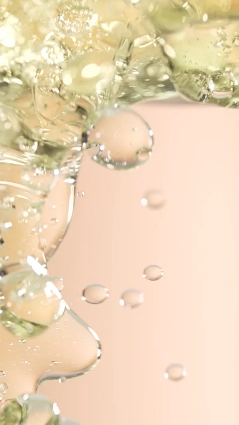 Macro shot of various air bubbles rising up on beige background. Slow motion. Stock Footage 300833588