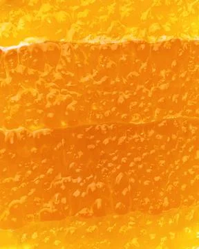 Macro shot of vibrant orange slice with glistening pulp forming a juicy Stock Photos