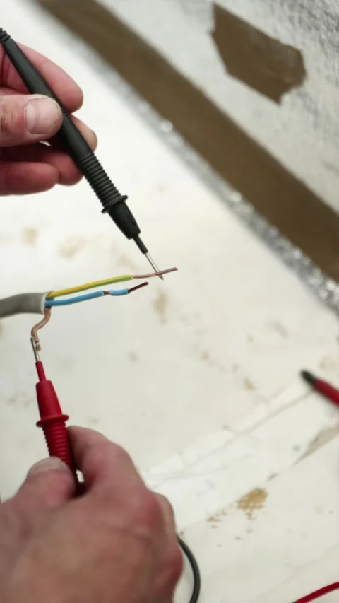 Macro shot of voltage tester probes touching copper wires vertical Stock Footage 339298298