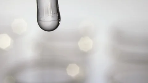 Macro shot of a water drop with test tubes reflection Video stock 100592126