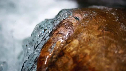 Macro shot of water spilling over a rock in the mountain river. Stock Footage 159723048