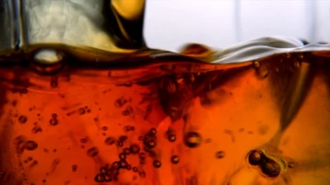 Macro shot of whiskey being poured. Slow motion 4k Stock Footage 89651113