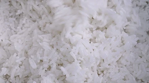 Macro Shot of White Cooked Rice Being Stirred with a Wooden Spoon 動画素材 339079270