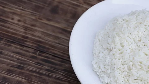 Macro Shot of White Cooked Rice Being Stirred with a Wooden Spoon 動画素材 339079279