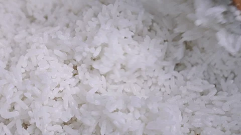 Macro Shot of White Cooked Rice Being Stirred with a Wooden Spoon Stock Footage 341441030