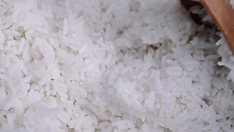 Macro Shot of White Cooked Rice Being Stirred with a Wooden Spoon Vidéo 344989526