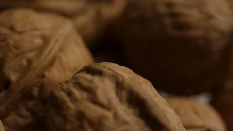 Macro shot of whole walnut shells with wrinkled texture Stock Footage 328144003