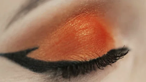 Macro shot of woman's eye. Orange bright eyeshadows. Stock Footage 121340398