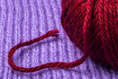 Macro shot of woolen thread  and a skein on a knitted background Stock Photos