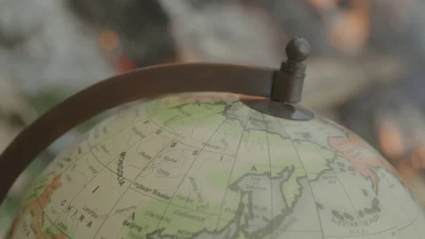 Macro Shot of a World Globe in Front of an Outdoor Fire with Bokeh Effect 動画素材 208803261
