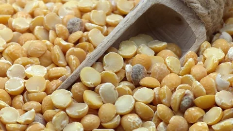 Macro shot of yellow split peas with wooden scoop Stock Footage 327793670