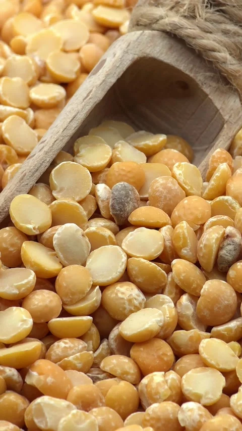 Macro shot of yellow split peas with wooden scoop Stock Footage 327869733