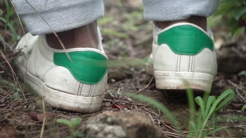 Macro shot of young man walking forward in nature indian with shoes sneekers Video stock 109610266