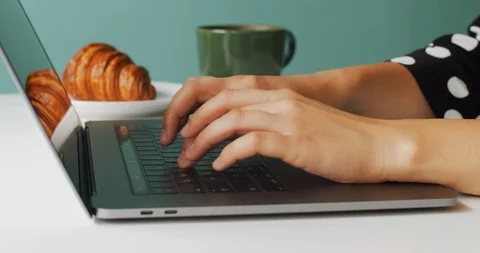 Macro side view of female hands typing laptop keyboard indoors cafe Stock Footage 113730982
