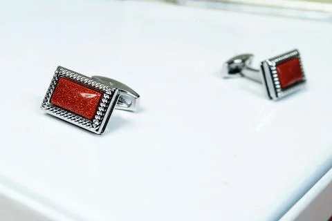 Macro silver red men sleeve button isolated shiny glitter stone in metal cuff Stock Photos