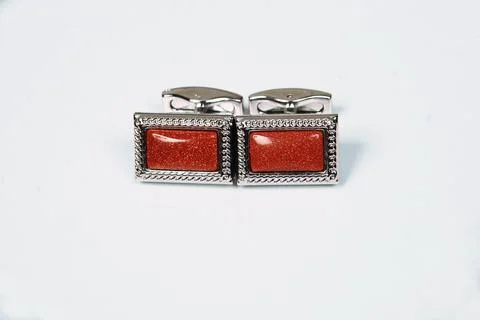Macro silver red men sleeve button isolated shiny glitter stone in metal cuff Stock Photos