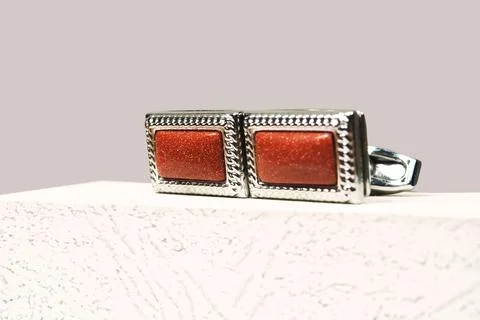 Macro silver red men sleeve button isolated shiny glitter stone in metal cuff Stock Photos