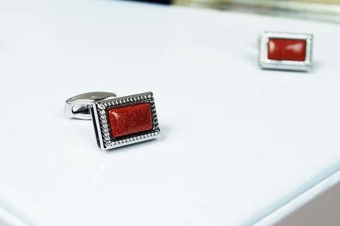 Macro silver red men sleeve button isolated shiny glitter stone in metal cuff Stock Photos