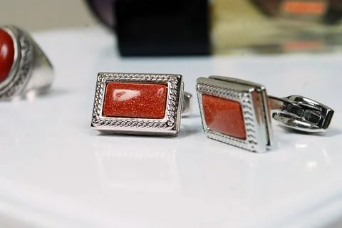 Macro silver red men sleeve button isolated shiny glitter stone in metal cuff Stock Photos