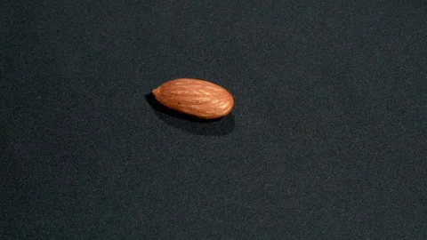 Macro Single Raw Almond Rotating On Black Background 4K Stock Footage 332844668