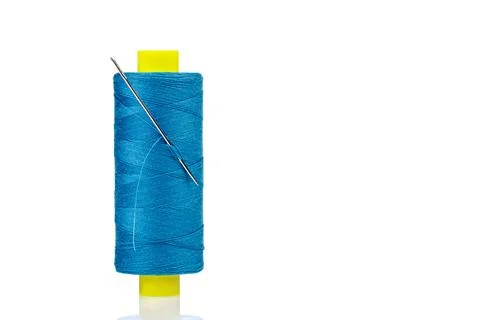 Macro skein of blue thread with a needle on a white background Stock Photos