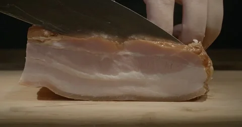 Macro of slicing bacon with a knife, video with a sound. Hands are slicing 스톡 동영상 221763964