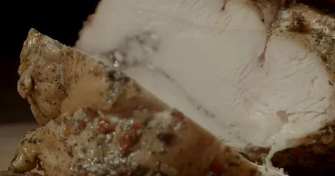 Macro of slicing brisket with a knife. Hands are slicing chicken breast at 스톡 동영상 221123961