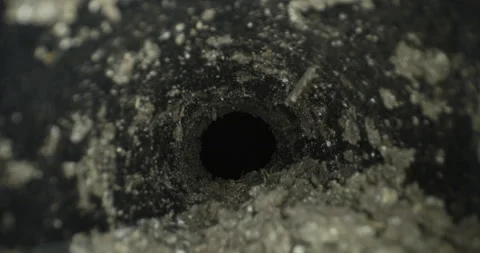Macro slider shot through underground tunnel pipe covered in dirt and mud Video stock 153919960