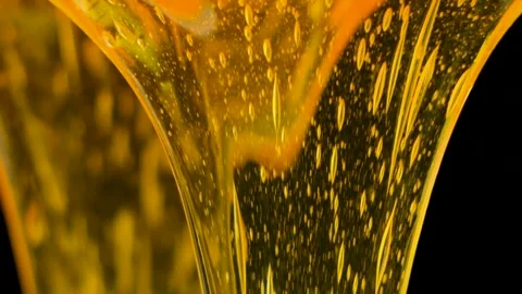 Macro Slow Motion Bee Honey, Flow and Texture Stock Footage 329913729