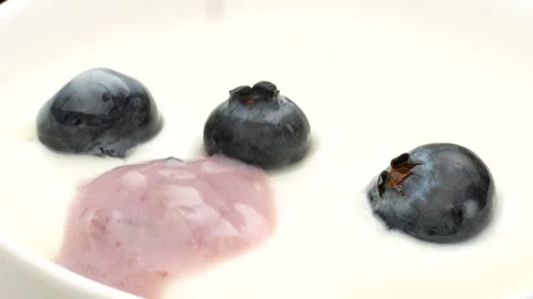 Macro Slow Motion Blueberry Juice Falling into White Yogurt Splash 4K Stock Footage 320661978