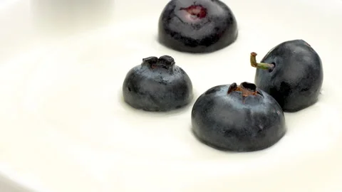 Macro Slow Motion Fresh Blueberry Falling into White Yogurt Splash 4K Stock Footage 320660913