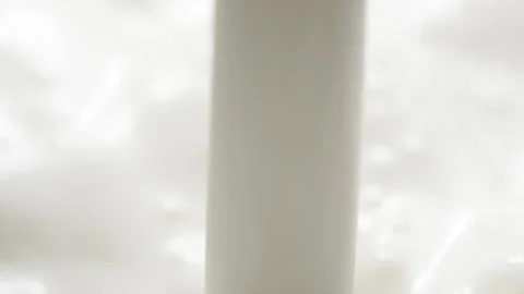 Macro slow motion pouring white milk, closeup splashing fresh drink with bubbles Stock Footage 197348246