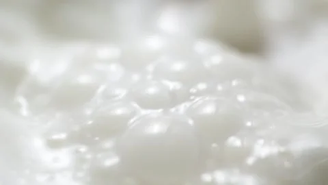 Macro slow motion pouring white milk, closeup splashing fresh drink with bubbles Stock-Footage 201735754