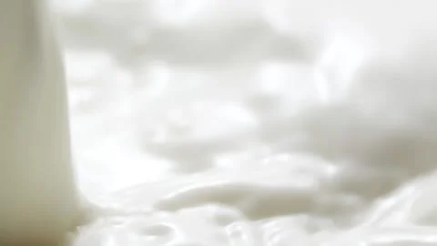 Macro slow motion pouring white milk, closeup splashing fresh drink with bubbles Stock Footage 201985207