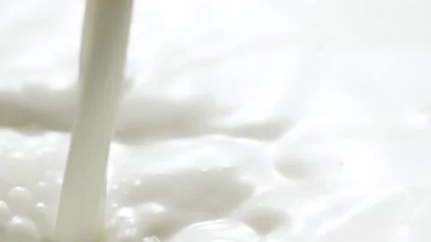 Macro slow motion pouring white milk, closeup splashing fresh drink with bubbles Stock Footage 208275137
