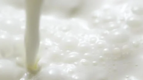 Macro slow motion pouring white milk, closeup splashing fresh drink with bubbles Stock Footage 210104823