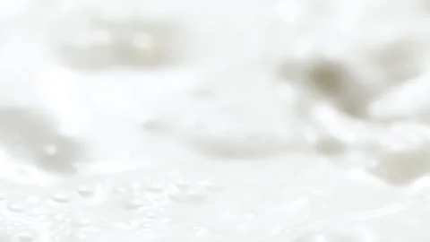 Macro slow motion pouring white milk, closeup splashing fresh drink with drops Stock Footage 233056993