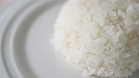 Macro slow motion shot of jasmine rice that is cooked and then served on a plate Stock Footage 160564342